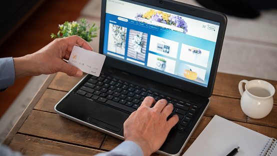 Senior man hand making purchases from shopping site with credit card