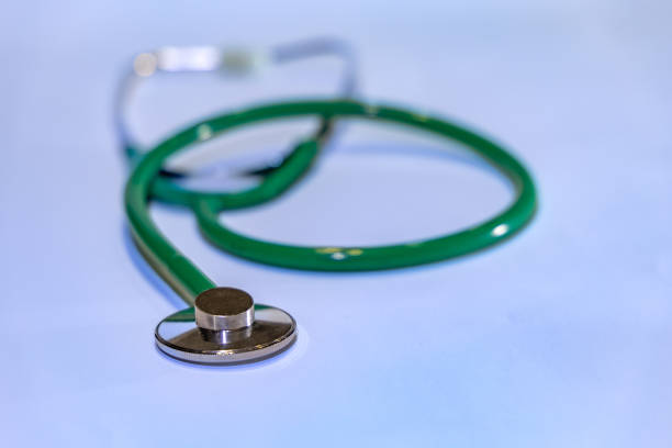 Examination with a stethoscope green medical stethoscope on the table for children