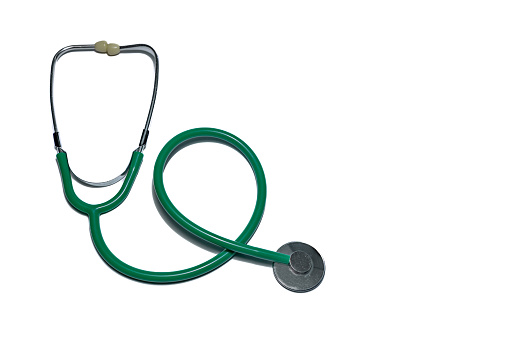 Examination with a stethoscope green medical stethoscope on the table for children