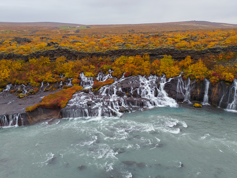 Aerial top view of Hraunfossar waterfall in autumn fall season in Iceland. Famous nature landscape background