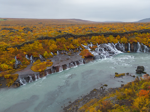 Aerial top view of Hraunfossar waterfall in autumn fall season in Iceland. Famous nature landscape background