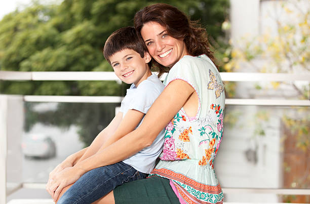 istock Mother and son smiling at camera 178044424