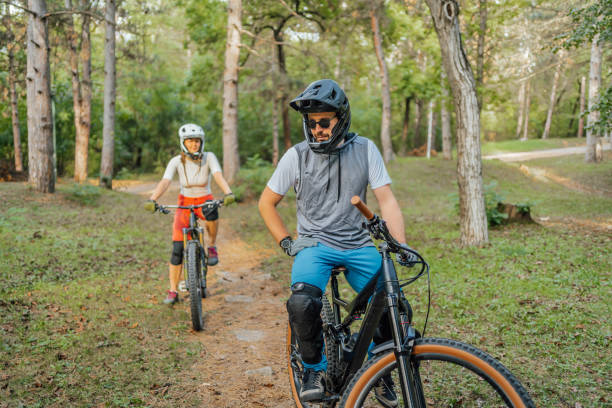 istock Man and woman riding mountain bikes through the forest 1780446674