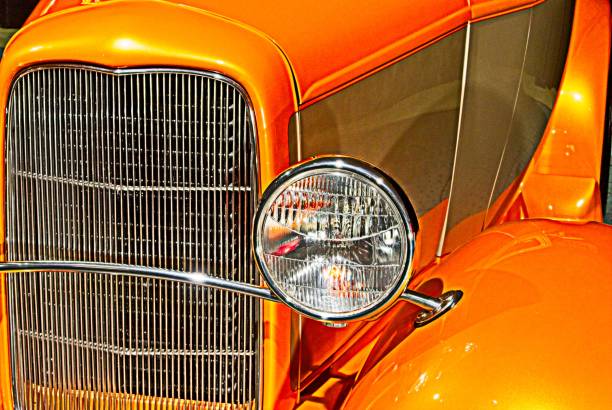 Vic, Spain – June 08, 2025: A retro photograph of a stunning maroon hot rod, based on an old Ford with a visible V8 Flathead engine.