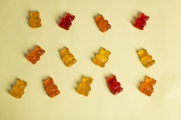 istock Gummy vitamins, gummy bears on yellow backgruond 1780460954