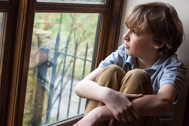 istock Sad Young Boy Child Looking Out Window 178047167