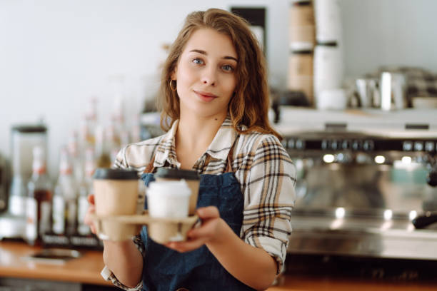 istock Female barista holding disposable takeaway cups. 1780471925