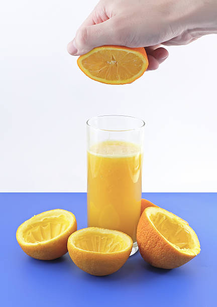 istock Orange juice with hand, squeeze of orange. 178049985