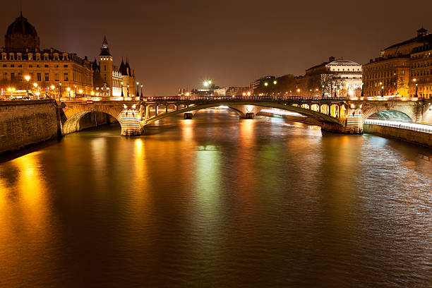 Seine river with pont notre dame and pont au change in Paris at night