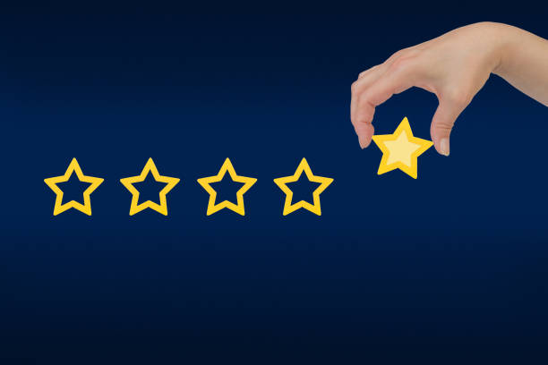 istock Woman's hand put the stars to complete five stars. Customer satisfaction concept. copy space and blue background. giving a five star rating. Service rating, satisfaction concept. 1780509886