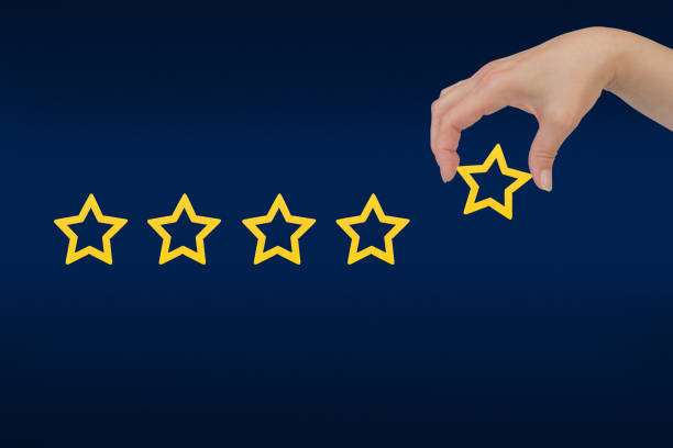 istock Woman's hand put the stars to complete five stars. Customer satisfaction concept. copy space and blue background. giving a five star rating. Service rating, satisfaction concept. 1780509915