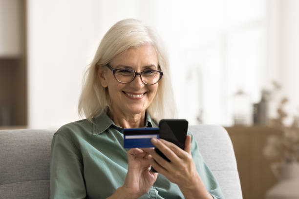 istock Happy senior woman using financial service for paying on Internet 1780510425