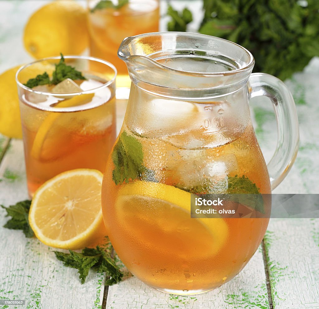 Iced tea Ice tea with mint and lemon on a white table Ice Tea Stock Photo