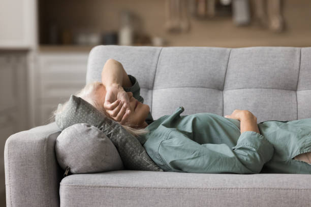istock Calm senior sleepy woman napping at home, lying on back 1780510982