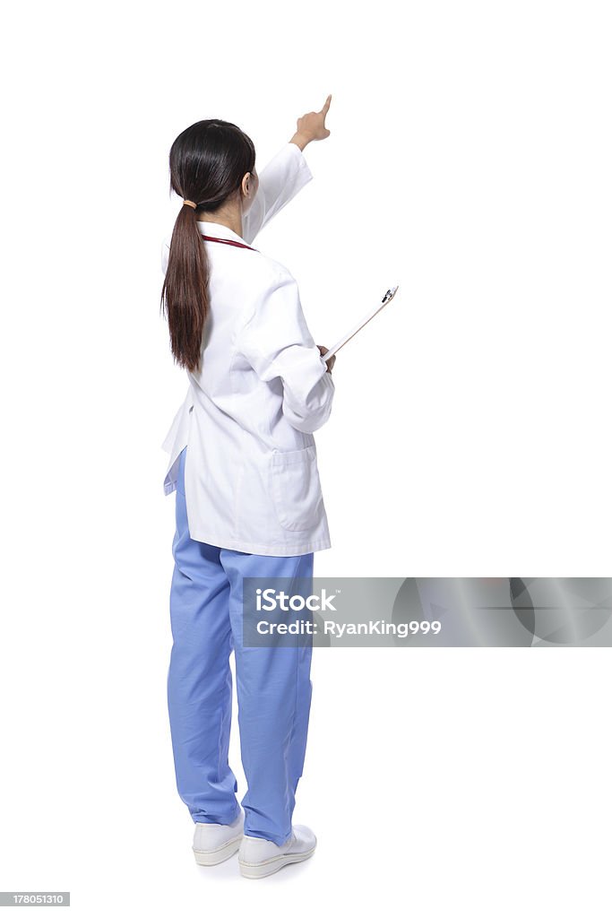 �Сзади на врач женщина палец точка - Стоковые фото Врач роялти-фри