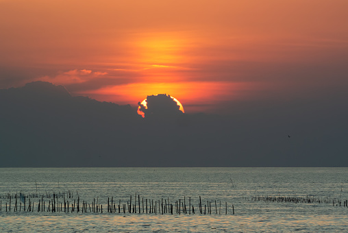Sunset back cloud in sea .