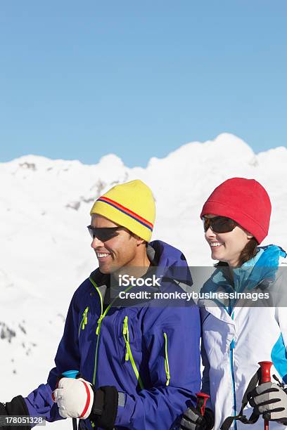 Couple Having Fun On Ski Holiday In Mountains Stock Photo - Download Image Now - 40-49 Years, Activity, Adult