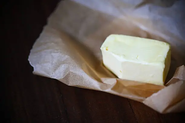 Photo of Raw butter on grease paper, homemade