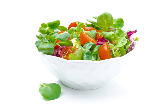 istock bowl of fresh salad and cherry tomatoes isolated on white 178052996