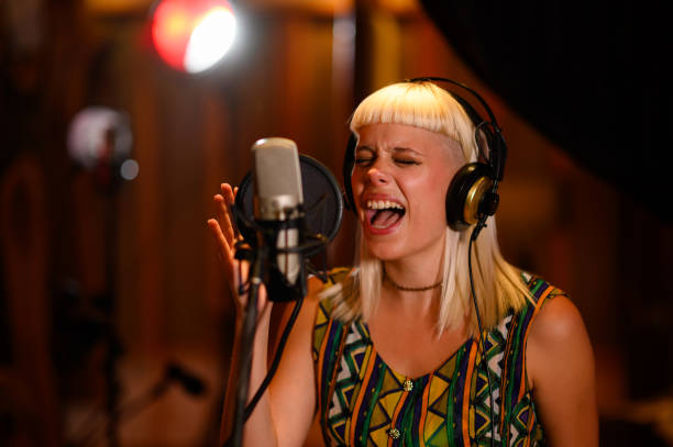 istock Close up of a singer giving her best performance in a studio silent room. 1780537720