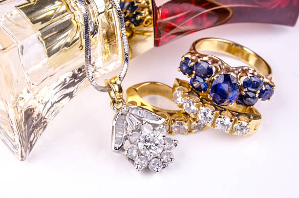 jewelry and perfume on white surface