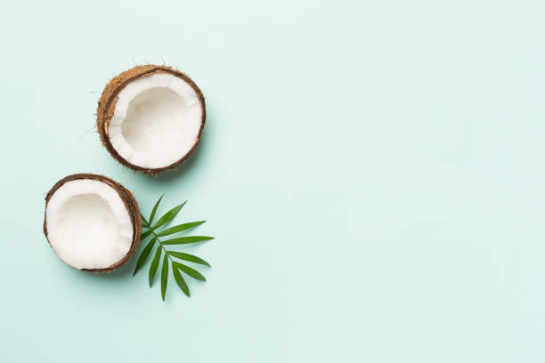 istock Coconut with leaves on color background, top view 1780545302