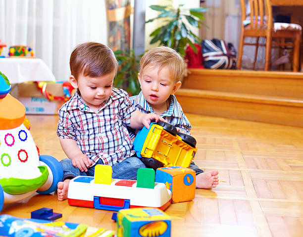 istock two cute baby toddlers playing in nursery room 178055666