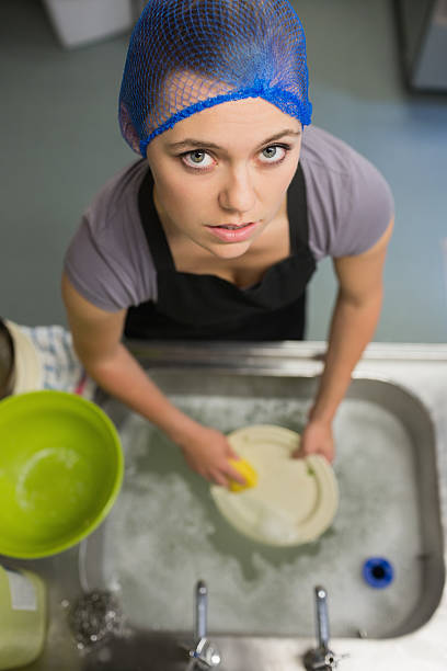 kobieta patrzy w górę od wykonywania prania - washing dishes restaurant manual worker commercial kitchen zdjęcia i obrazy z banku zdjęć