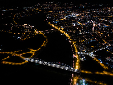 Drone photo of a city at nights. The city is Novi Sad located in Serbia. Beautiful aerial view of bridges connecting parts of a city.