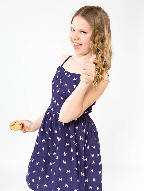 Smiling teenage girl holding a delicious cake stock photo