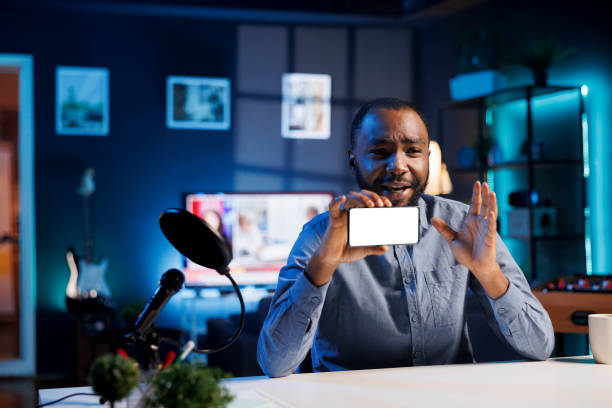 istock Man watching videos on mockup phone 1780575690