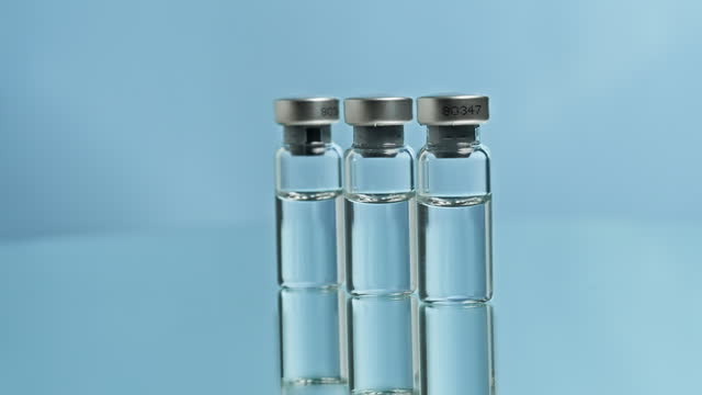 Vaccine glass bottle vials on laboratory turning desk