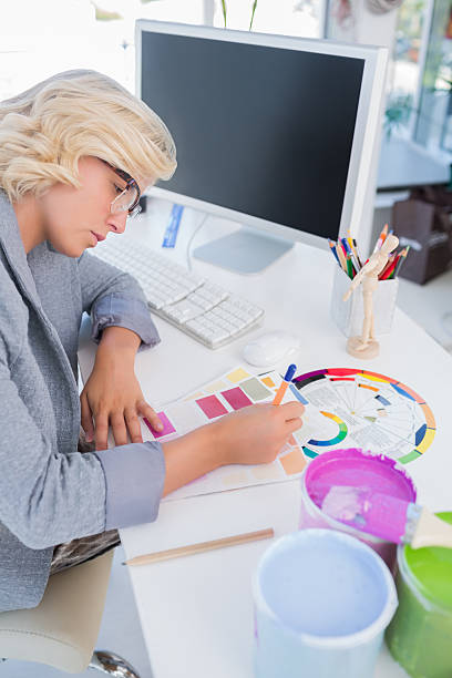 istock Concentrated interior designer looking at colour charts 178057911