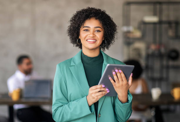 istock Smiling Black Lady Posing With Digital Tablet Standing In Office 1780589513