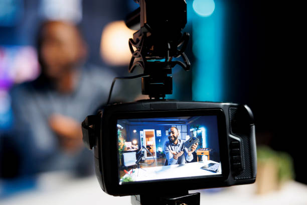 istock Man filming V mount battery review 1780592217