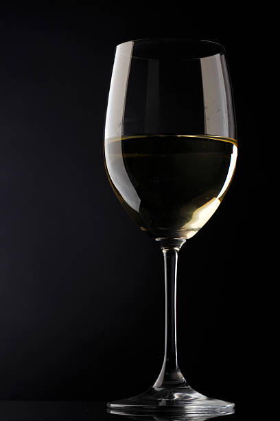 istock white wine glass silhouette black background 178059794
