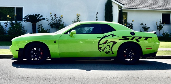 Fresno, United States – November 01, 2023: Photo of a Neon green Dodge SRT Sports car parked on the street