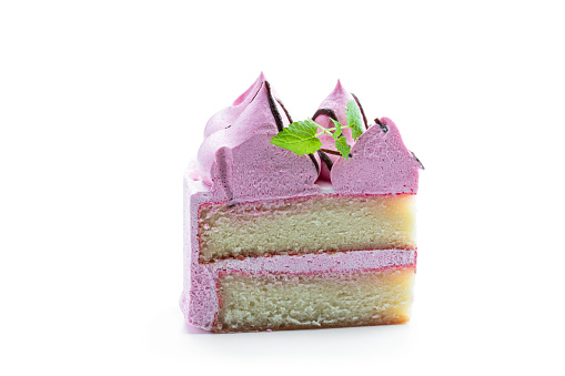 Pink  Sponge cake slice decorated with small meringue on top isolated on white