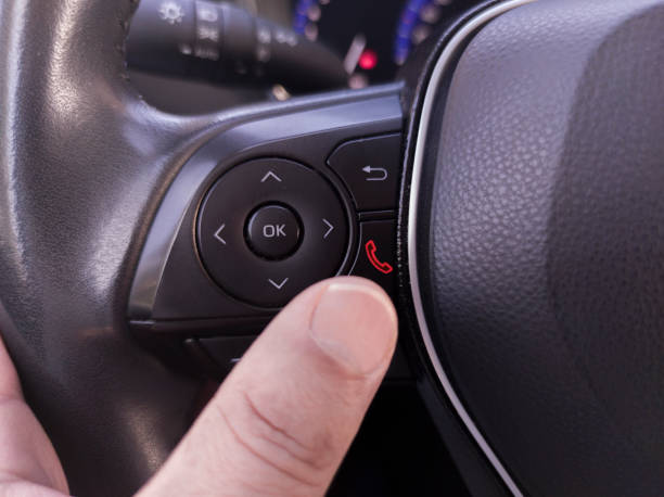 istock Driver about to hang up the phone from the steering wheel controls 1780611340