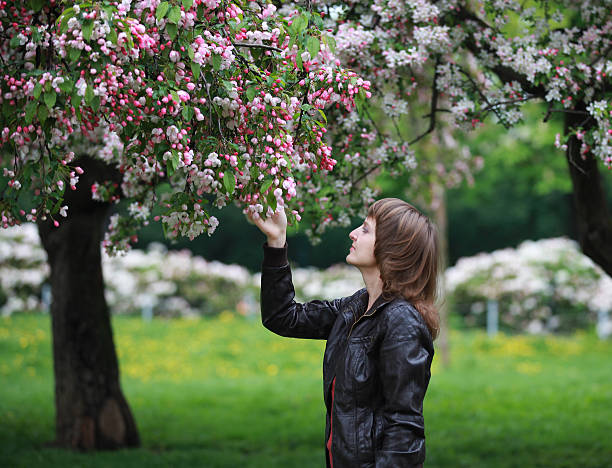 Girl in blooming park stock photo