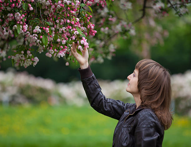 Girl looking at blooming tree stock photo