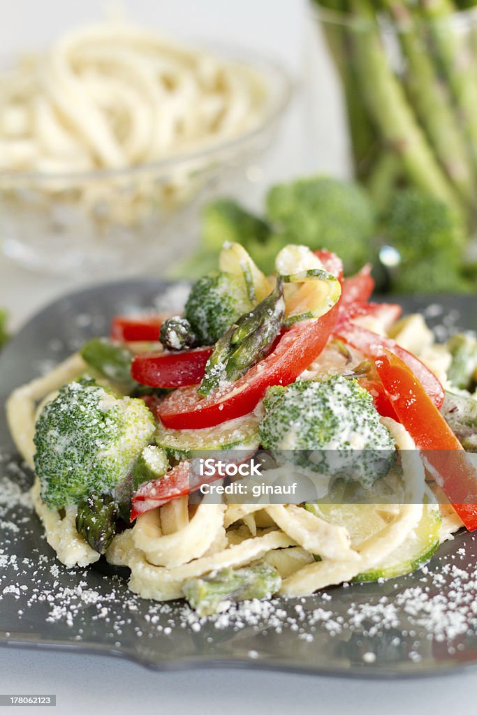 pasta primavera side angle a photo of freshly prepared pasta primavera, dusted with Parmesan cheese Asparagus Stock Photo