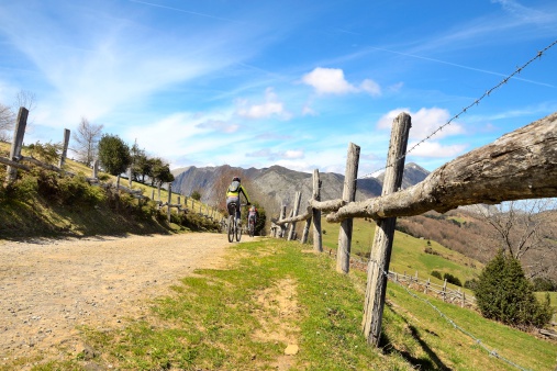 Landscape in the Asturias. Two cyclists are riding their bikes in a beautiful place.