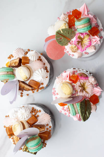 istock Orthodox easter bread richly decorated with sweets, macaroons, chocolate and edible flowers with salted caramel filling 1780632667