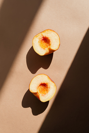 Still life with fresh peaches. Photos in natural colors. Minimal food concept with dramatic light and shadow