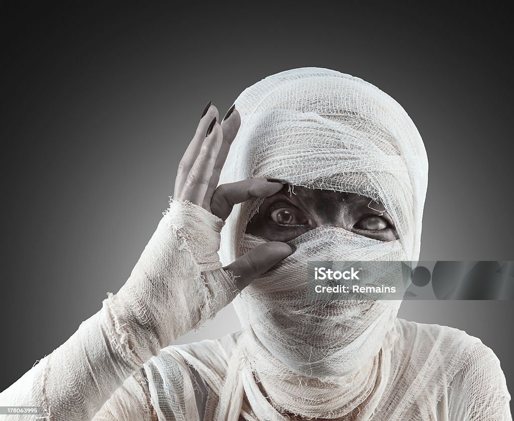 Halloween mummy looks at you. Mummy opens her eyes to see you and invite to a party Halloween. Mummified Stock Photo