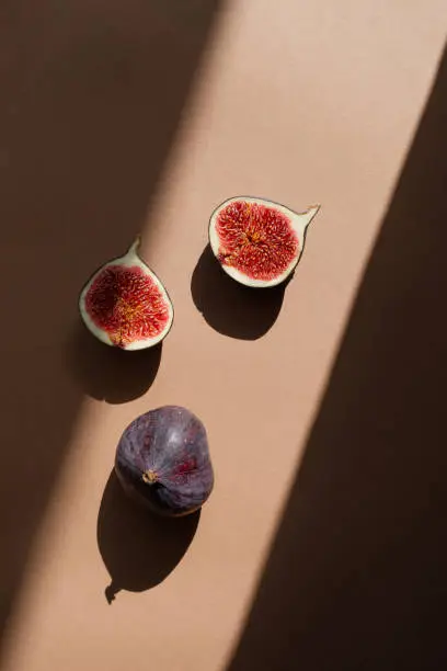 Photo of Still life with figs. Photos in natural colors. Minimal food concept with dramatic light and shadow