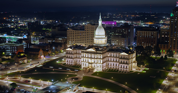 Aerial shot of the Michigan State Capitol Building in Lansing in pre-dawn darkness on a Fall morning. \n\nAuthorization was obtained from the FAA for this operation in restricted airspace.