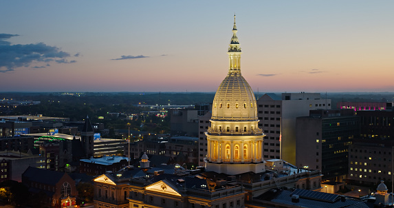 Aerial shot of the Michigan State Capitol Building in Lansing before sunrise on a Fall morning. \n\nAuthorization was obtained from the FAA for this operation in restricted airspace.