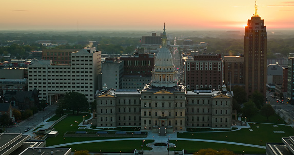 Aerial shot of the Michigan State Capitol Building in Lansing at sunrise on a Fall morning. \n\nAuthorization was obtained from the FAA for this operation in restricted airspace.